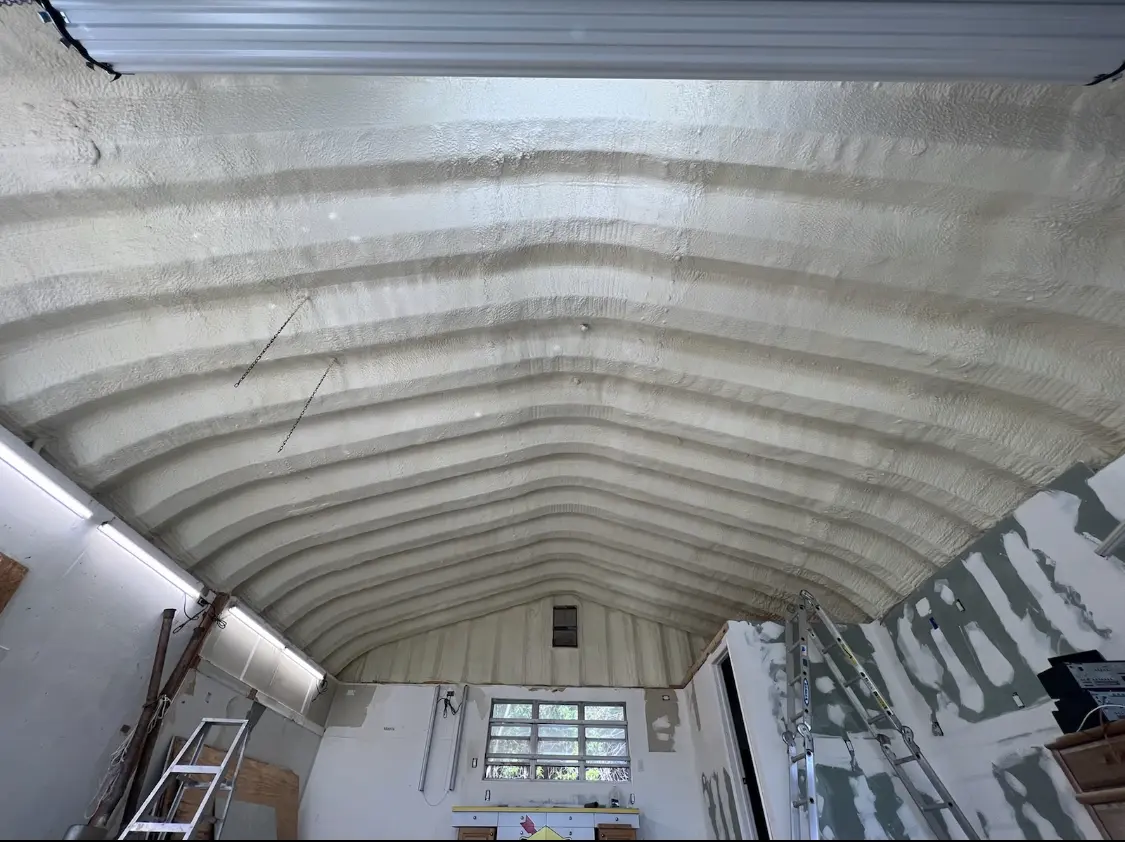 Spray polyurethane foam applied to the underside of a metal roof deck in Deerfield